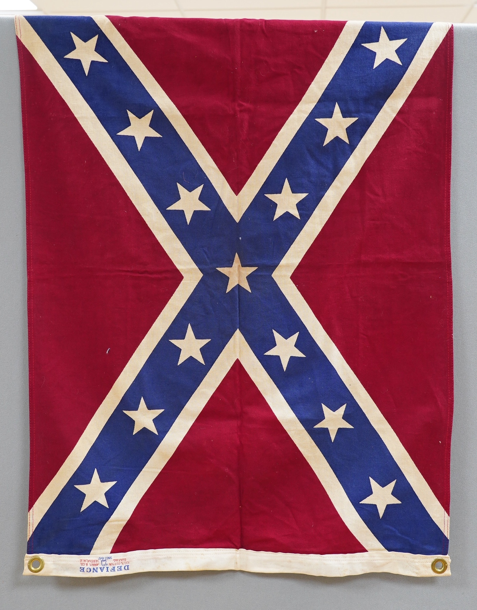 Four early to mid 20th century flags including; two Union Jack flags, a British naval ensign and an American confederate flag, 62 x 86cm. Condition - poor to fair